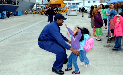 US Navy 100514-N-7478G-135 Information Systems Technician 1st Class Melvin McCullough greets his daughters during the U.S. 7th Fleet command ship USS Blue Ridge (LCC 19) homecoming