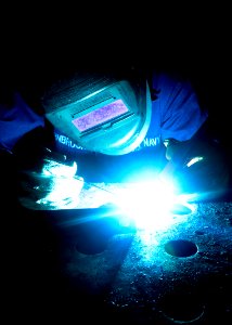 US Navy 100520-N-7908T-035 Hull Technician 3rd Class Joseph L. Vornbrock welds wall mounts in the sheet metal shop aboard USS George H.W. Bush (CVN 77)