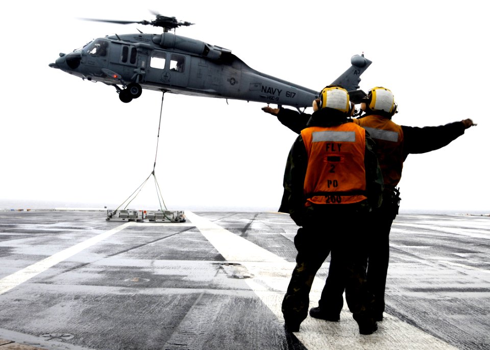 US Navy 100518-N-6509M-001 Sailors assigned to USS George H.W. Bush (CVN 77) direct an MH-60S Sea Hawk helicopter during a vertical replenishment