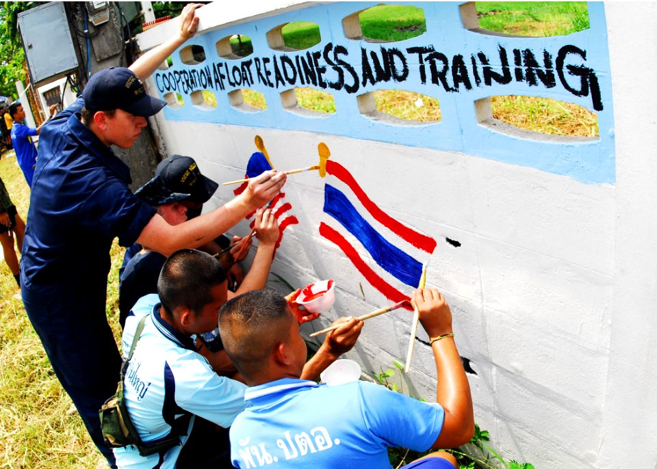 US Navy 100515-N-0995C-171 Coast Guardsmen assigned to the U.S. Coast Guard cutter Mellon (WASC 717) help Thai school children paint a mural symbolizing Cooperation Afloat Readiness and Training (CARAT) Thailand 2010