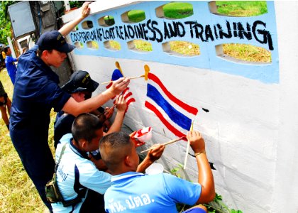 US Navy 100515-N-0995C-171 Coast Guardsmen assigned to the U.S. Coast Guard cutter Mellon (WASC 717) help Thai school children paint a mural symbolizing Cooperation Afloat Readiness and Training (CARAT) Thailand 2010