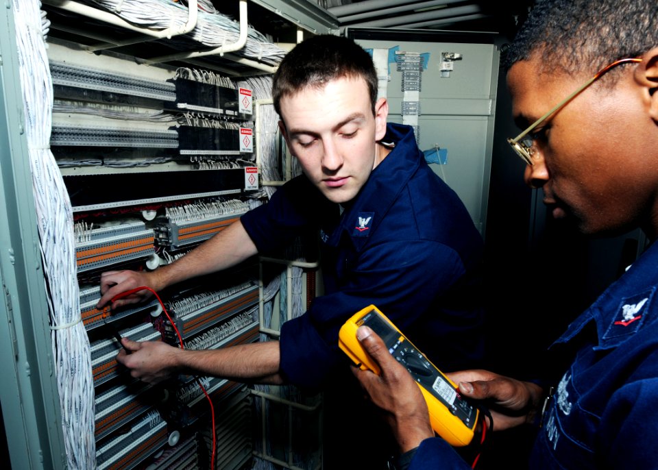 US Navy 100520-N-8913A-096 Interior Communications Electricians 3rd Class Rory J. Shisler, left, and Larry O. Hughes perform maintenance on the internal phone system aboard USS George H.W. Bush (CVN 77)