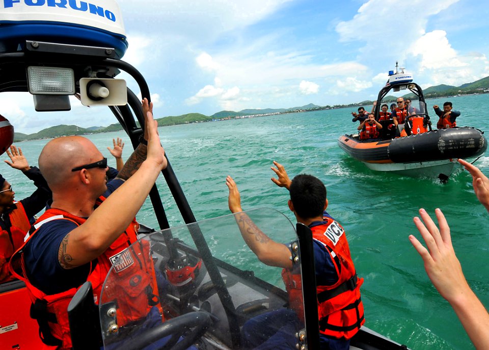 US Navy 100516-N-7643B-211 U.S. Coast Guardsmen role-playing as suspects hold their hands in the air as Royal Thai Navy sailors approach