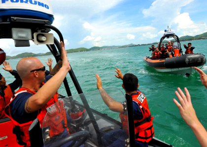 US Navy 100516-N-7643B-211 U.S. Coast Guardsmen role-playing as suspects hold their hands in the air as Royal Thai Navy sailors approach photo