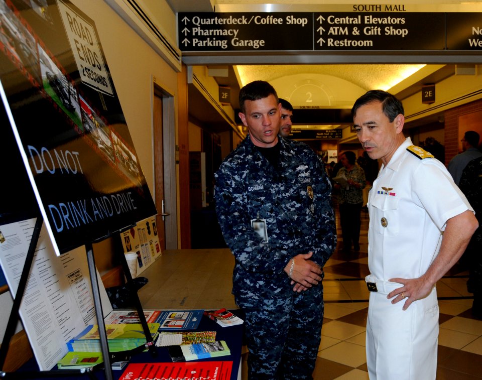 US Navy 100514-N-6686P-182 Master-at-Arms 2nd Class Jerry M. Bonham discusses the security department's drunk driving awareness display with Vice Adm. Harry Harris