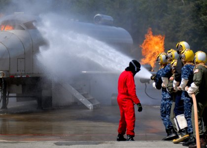 US Navy 100518-N-9520G-002 Sailors from various commands combat a simulated flight deck fire during a flight deck fire fighting course at the Center for Naval Aviation Technical Training Unit Whidbey Island photo