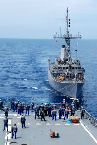 US Navy 100522-N-0000X-824 The mine countermeasures ship USS Defender (MCM 2) receives lines from the Japan Maritime Self-Defense Force minesweeping support vessel JS Uraga (MST 463)