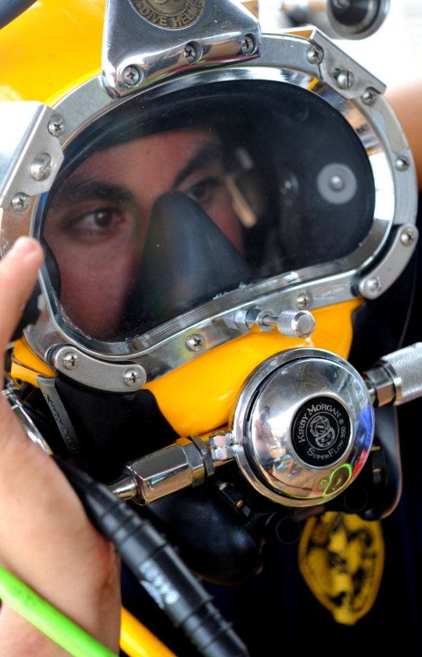 US Navy 100522-N-0413B-147 Navy Diver 2nd Class Jessie Trujillo, assigned to Mobile Diving and Salvage Unit (MDSU) 1, conducts voice checks in a MK-3 dive helmet