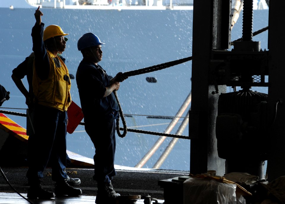 US Navy 100519-N-5838W-006 Boatswain's Mate 2nd Class Quinton Shoulders instructs a line-handler during an underway replenishment
