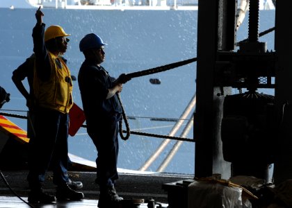 US Navy 100519-N-5838W-006 Boatswain's Mate 2nd Class Quinton Shoulders instructs a line-handler during an underway replenishment
