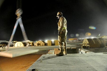 US Navy 100519-N-0475R-075 Equipment Operator 2nd Class Alain Gbla helps direct crane operations at Camp Leatherneck, Afghanistan