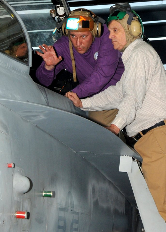 US Navy 100522-N-7908T-032 Cmdr. William Pennington describes the cockpit of an F-A-18C Hornet to Under Secretary of Defense (Comptroller) Robert F. Hale