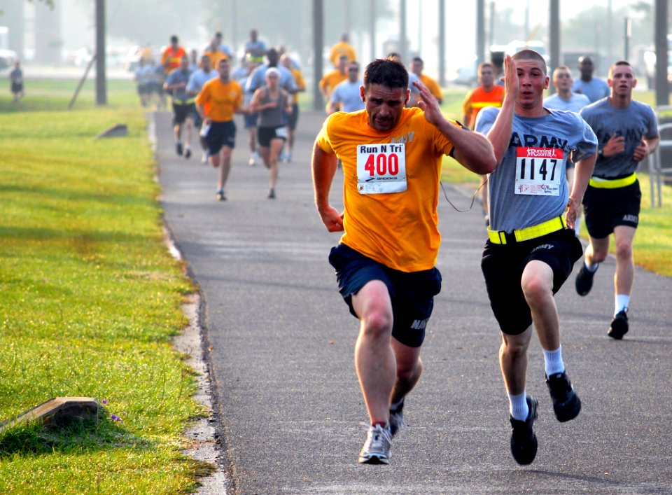 US Navy 100519-N-7367K-001 A Sailor and a Soldier based in southern Mississippi sprint to the finish line during the Run for Relief 5K Challenge