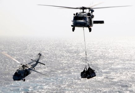 US Navy 100520-N-4236E-216 Two MH-60S Sea Hawk helicopters assigned to the Chargers of Helicopter Sea Combat Squadron (HSC) 26 conduct a vertical replenishment