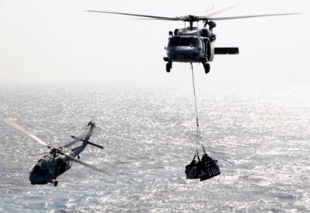 US Navy 100520-N-4236E-216 Two MH-60S Sea Hawk helicopters assigned to the Chargers of Helicopter Sea Combat Squadron (HSC) 26 conduct a vertical replenishment photo