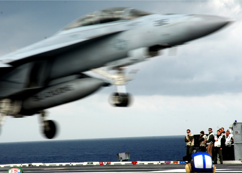 US Navy 100519-N-7908T-207 Landing signal officers aboard the aircraft carrier USS George H.W. Bush (CVN 77) watch as a F-A-18F Super Hornet assigned to Strike Fighter Squadron (VFA) 213 lands