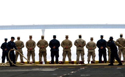 US Navy 100522-N-7948R-424 Sailors and Marines man the rails aboard USS Peleliu (LHA 5) as the ship departs San Diego for a scheduled deployment