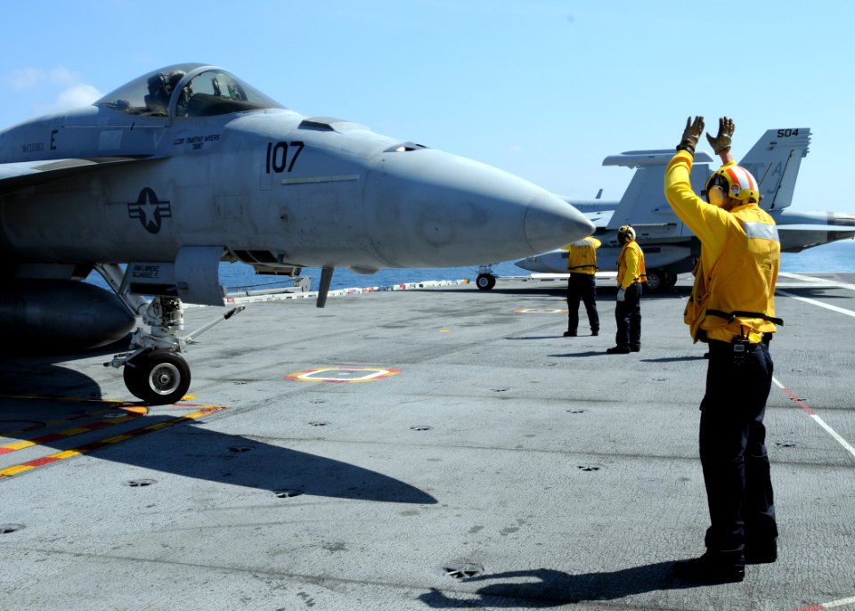 US Navy 100520-N-6509M-459 Sailor directs an F-A-18E Super Hornet