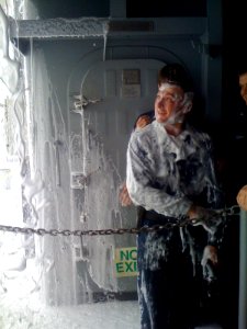 US Navy 100519-N-5503T-002 Machinist's Mate 1st Class Aaron Botts is covered in aqueous film forming foam during a countermeasure washdown photo