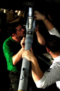 US Navy 100523-N-6604E-130 Aviation Structural Mechanic 2nd Class Marc Kirschenheiter and Aviation Structural Mechanic 3rd Class Stephen Tedder perform maintenance on an F-A-18F Super Hornet