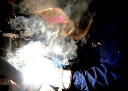 US Navy 100520-N-7908T-100 Hull Technician 3rd Class Joseph L. Vornbrock welds wall mounts in the sheet metal shop aboard USS George H.W. Bush (CVN 77)