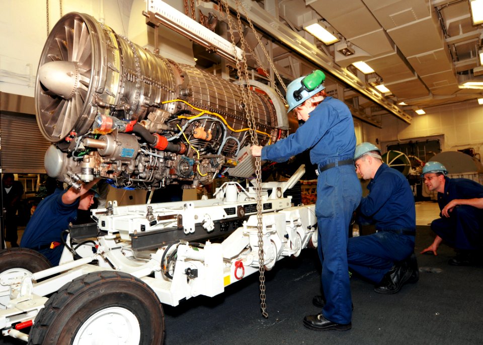 US Navy 100520-N-8913A-135 Sailors assigned to USS George H.W. Bush (CVN 77) lower a jet engine onto an engine transport shuttle