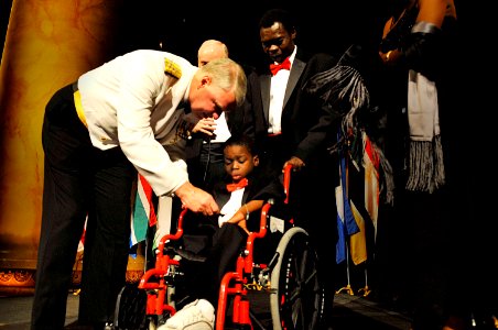 US Navy 100520-N-8273J-190 Chief of Naval Operations (CNO) Adm. Gary Roughead gives his command coin to Haiti earthquake survivor 8-year-old Dave Louizard