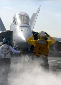 US Navy 100521-N-3885H-102 A Sailor guides an F-A-18F Super Hornet