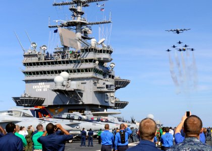 US Navy 100521-N-3620B-073 Sailors and Marines watch the U.S. Navy flight demonstration team, the Blue Angels, perform an air-power demonstration over the aircraft carrier USS Enterprise (CVN 65)
