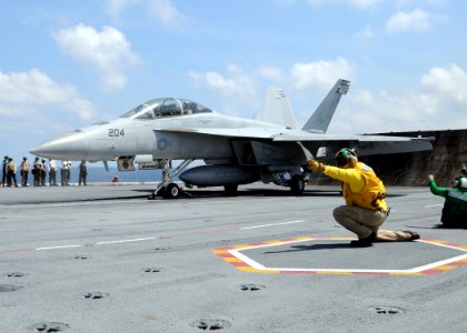 US Navy 100520-N-6509M-200 A shooter signals an F-A-18F Super Hornet to launch from USS George H.W. Bush (CVN 77)