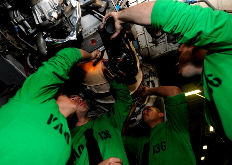 US Navy 100524-N-7191M-042 Sailors assigned to the Gauntlets of Electronic Attack Squadron (VAQ) 136 install an air intake duct on an EA-6B Prowler aboard the aircraft carrier USS George Washington (CVN 73)