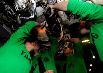 US Navy 100524-N-7191M-042 Sailors assigned to the Gauntlets of Electronic Attack Squadron (VAQ) 136 install an air intake duct on an EA-6B Prowler aboard the aircraft carrier USS George Washington (CVN 73)