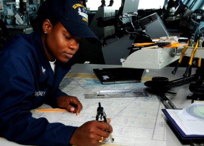 US Navy 100524-N-8913A-060 Quartermaster 3rd Class La-Tanya Pinckney charts a course on the ship's bridge