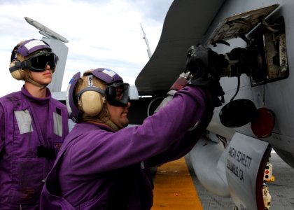 US Navy 100522-N-6509M-156 Sailors assigned to V4 Division of the air department aboard the aircraft carrier USS George H.W. Bush (CVN 77) fuel an F-A-18A Hornet
