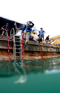 US Navy 100525-N-0413B-005 Dr. Eric Emery, an underwater anthropologist assigned to Joint POW-MIA Personnel Accounting Command (JPAC), jumps off a barge