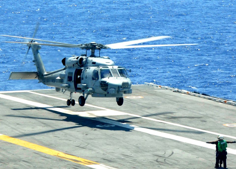 US Navy 100521-N-7908T-005 A Sailor guides irects an MH-60S Sea Hawk helicopter