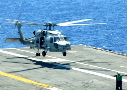 US Navy 100521-N-7908T-005 A Sailor guides irects an MH-60S Sea Hawk helicopter