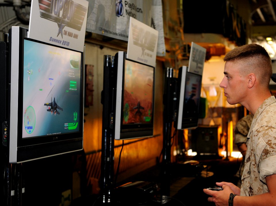 US Navy 100525-N-1831S-004 A Sailors en route to Fleet Week New York aboard the multipurpose amphibious assault ship USS Iwo Jima (LHD 7) play a demonstration copy of the new Top Gun video game