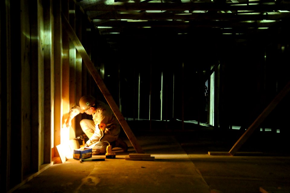 US Navy 100525-N-0475R-113 Construction Electrician 3rd Class Stanley Sejalbo, attached to Naval Mobile Construction Battalion (NMCB) 5, installs receptacle boxes on the project site at Camp Leatherneck, Afghanistan