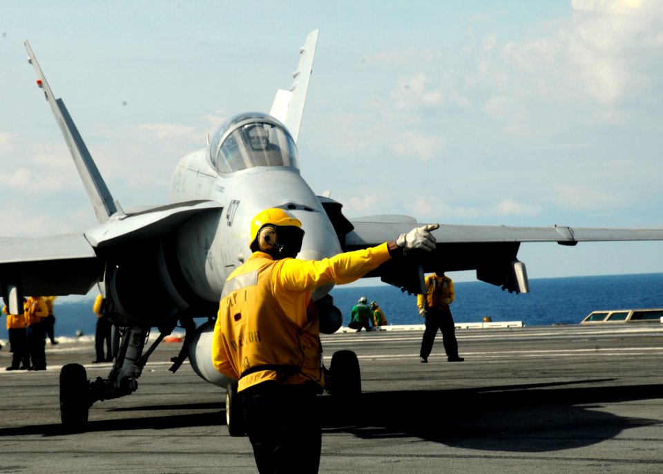 US Navy 100521-N-7908T-442 An air department Sailor directs an F-A-18C Hornet assigned to Strike Fighter Squadron (VFA) 15 for launch aboard the aircraft carrier USS George H.W. Bush (CVN 77)