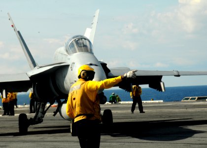 US Navy 100521-N-7908T-442 An air department Sailor directs an F-A-18C Hornet assigned to Strike Fighter Squadron (VFA) 15 for launch aboard the aircraft carrier USS George H.W. Bush (CVN 77)