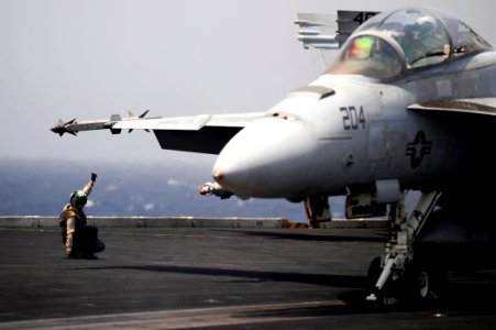 US Navy 100525-N-6604E-602 A Sailor signals for the launch of an F-A-18F Super Hornet aboard USS Dwight D. Eisenhower (CVN 69)