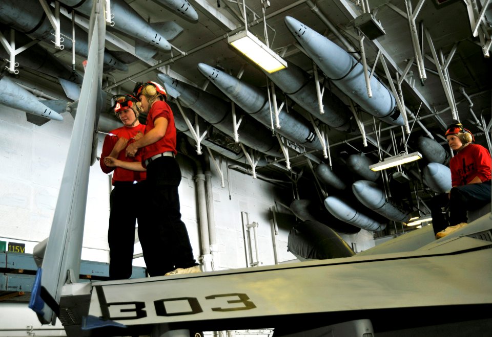US Navy 100525-N-6003P-076 Aviation Ordnancemen 3rd Class Eric Johnson and Robert Latner complete a 364-day inspection of an F-A-18C Hornet in the hangar bay of the Nimitz-class aircraft carrier USS Harry S. Truman (CVN 75)