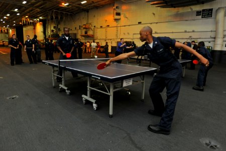 US Navy 100523-N-4516G-012 Aviation Support Equipment Technician 1st Class Steven T. White, left, and Aviation Support Equipment Technician 3rd Class Marlon G. Goodchild play ping pong during a morale, welfare and recreation to