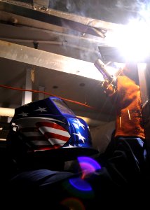 US Navy 100525-N-7191M-011 Hull Maintenance Technician 3rd Class Christopher Gault, from Bellevue, Neb., uses an arc welder to install a doorframe aboard the aircraft carrier USS George Washington (CVN 73)