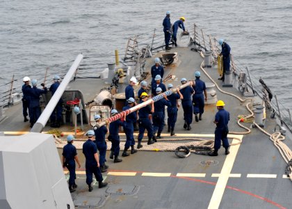 US Navy 100526-N-2013O-002 Sailors prepare to mount the flagstaff aboard the Arleigh Burke-class guided-missile destroyer USS Lassen (DDG 82) as the ship returns to Fleet Activities Yokosuka photo