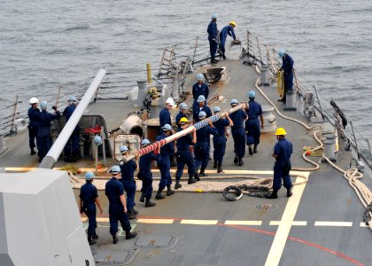 US Navy 100526-N-2013O-002 Sailors prepare to mount the flagstaff aboard the Arleigh Burke-class guided-missile destroyer USS Lassen (DDG 82) as the ship returns to Fleet Activities Yokosuka