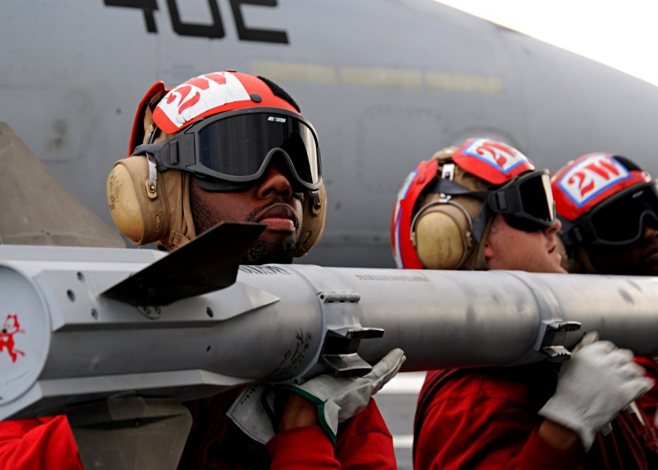 US Navy 100522-N-3885H-034 Sailors assigned to the weapons department of Strike Fighter Squadron (VFA) 31 load ordnance onto an F-A-18 Hornet aboard the aircraft carrier USS George H.W. Bush (CVN 77)
