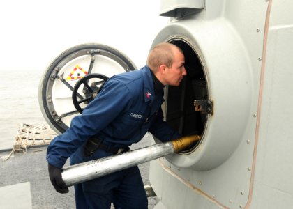 US Navy 100522-N-9301W-318 Gunner's Mate 2nd Class Joeseph Christos loads a 76mm round into the main deck gun for a firing exercise aboard the guided-missile frigate USS Klakring (FFG 42)