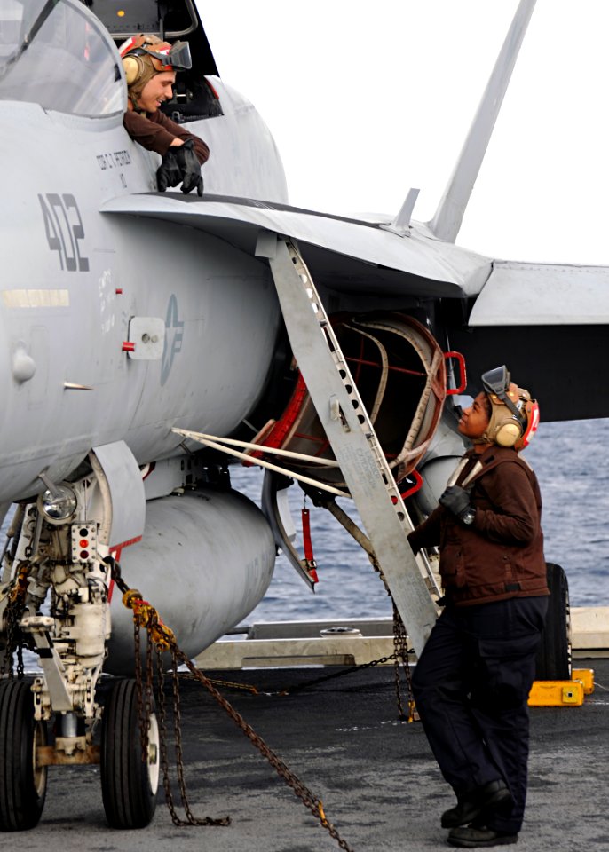 US Navy 100522-N-3885H-061 Sailors assigned to Strike Fighter Squadron (VFA) 87 talk on the flight deck before flight operations aboard the aircraft carrier USS George H.W. Bush (CVN 77)